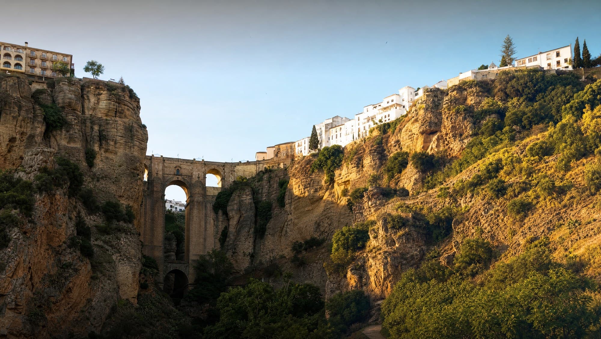 Puente Nuevo bridge over the El Tajo gorge in Ronda at golden hour — the iconic day trip from Marbella