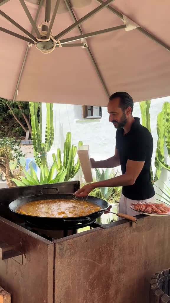 Guest cooking paella at the finca